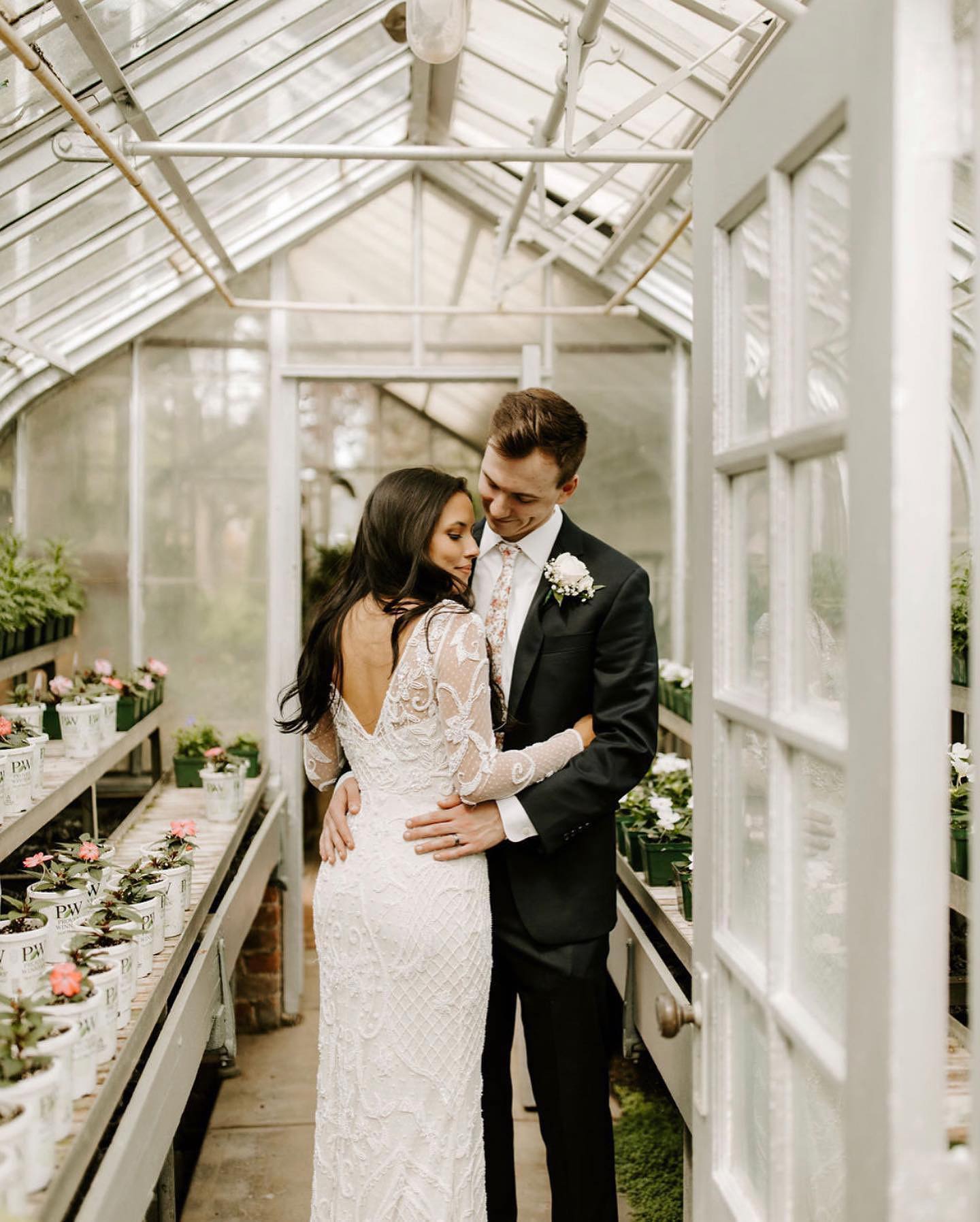 bride and groom in a greenhouse