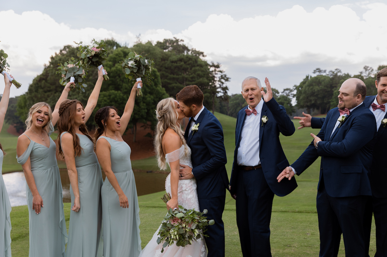 les mariés s'embrassent et fête nuptiale célébrant - mariage d'été en Géorgie 