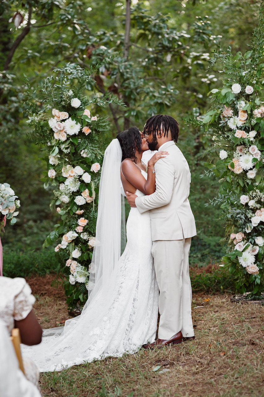 bride and groom kissing at altar - backyard wedding in Georgia