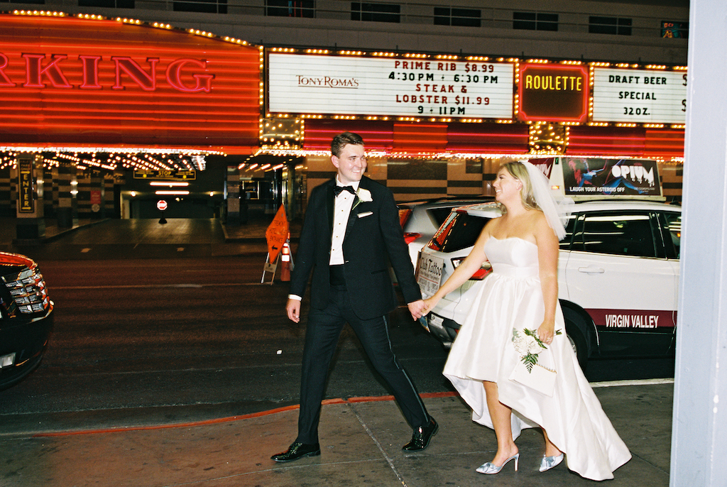 couple walking down the street at night - las vegas elopement