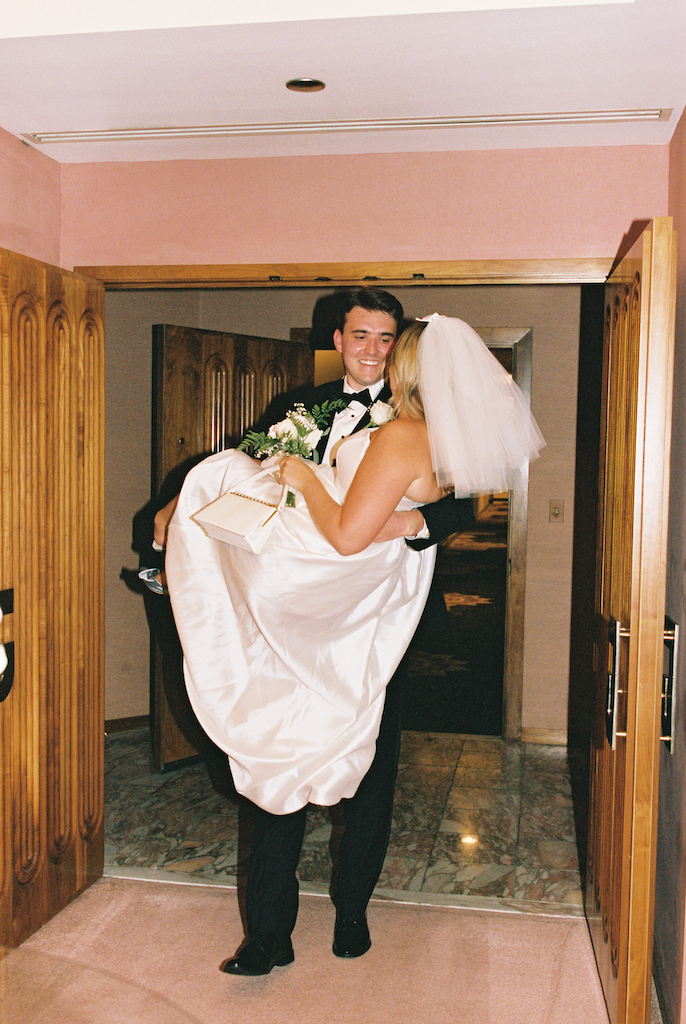 groom carrying bride