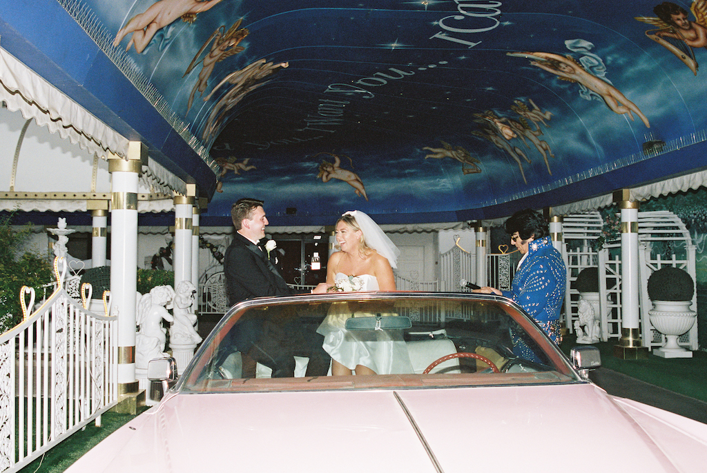 bride and groom in pink cadillac 