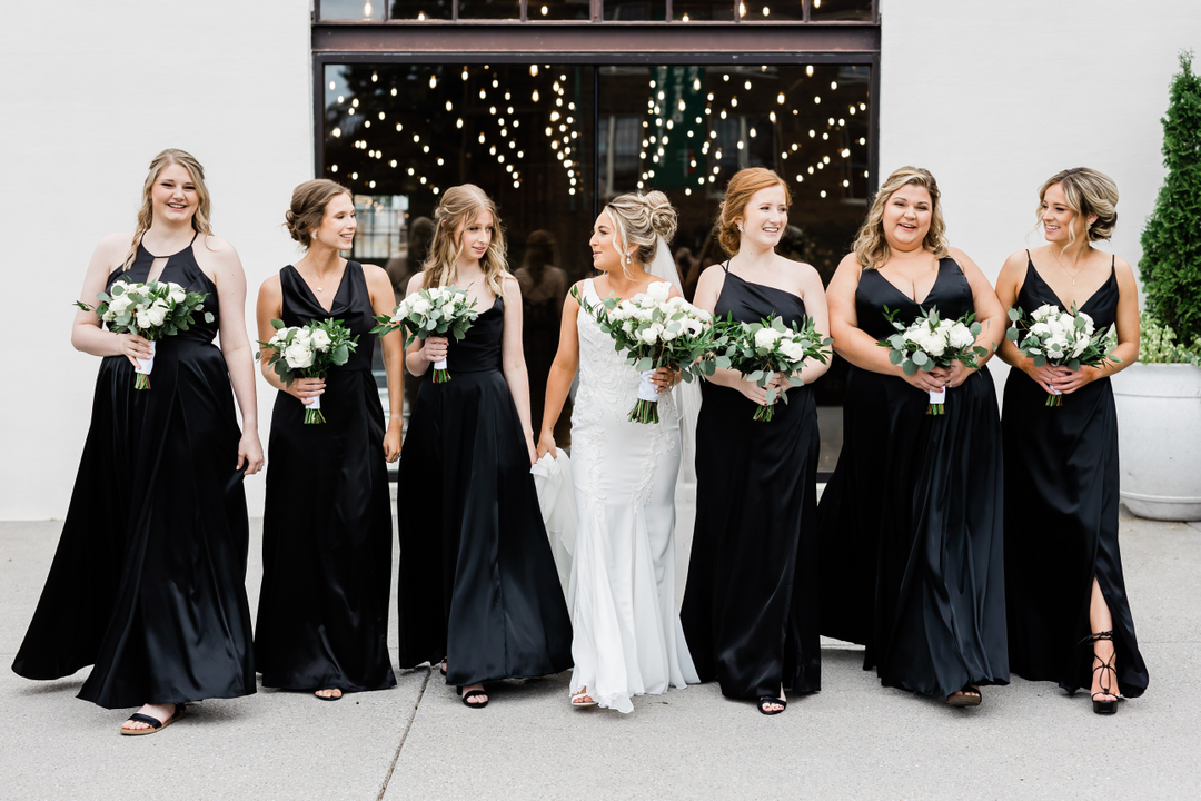 bridal party walking in black bridesmaid dresses
