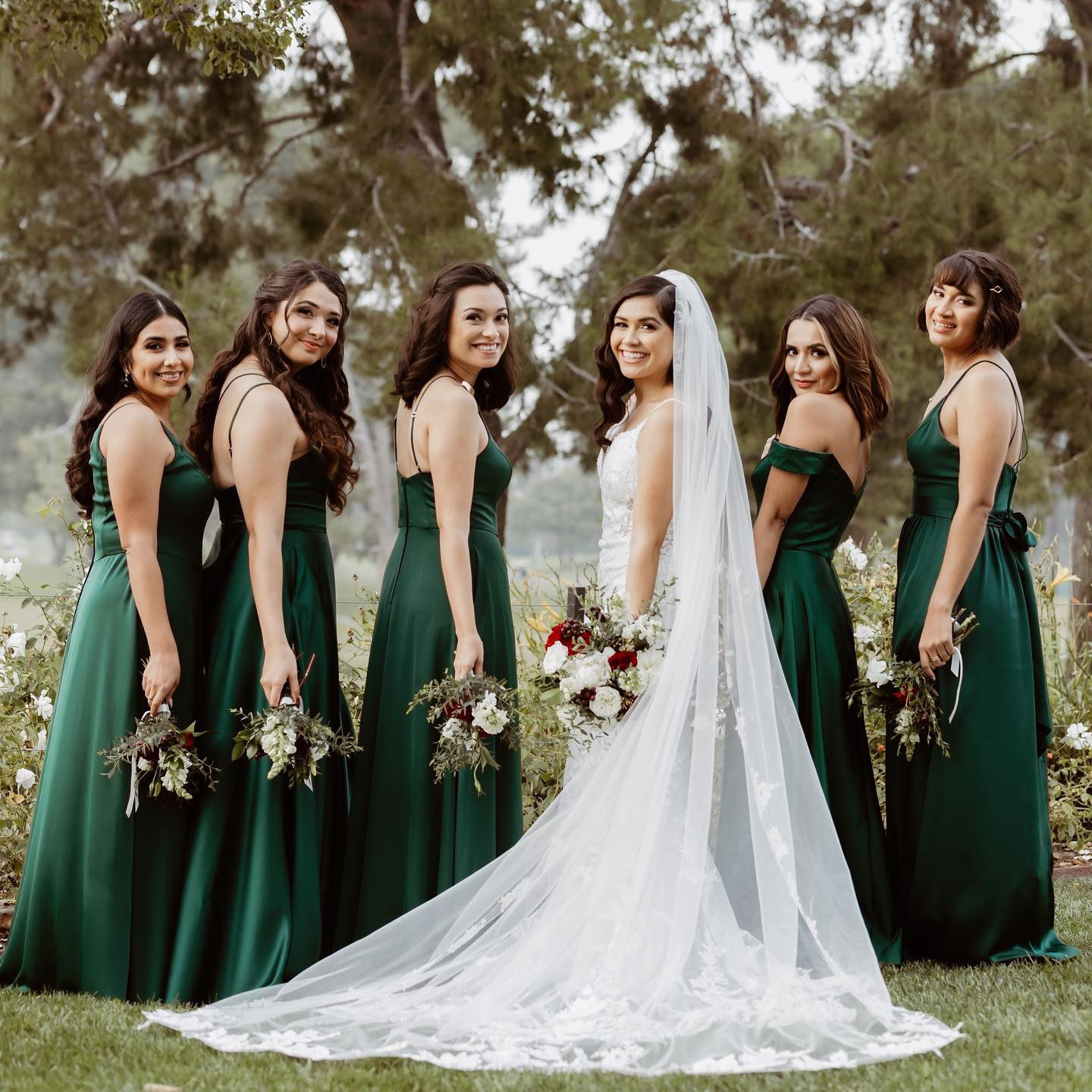 bride and bridesmaid wearing green bridesmaid dresses
