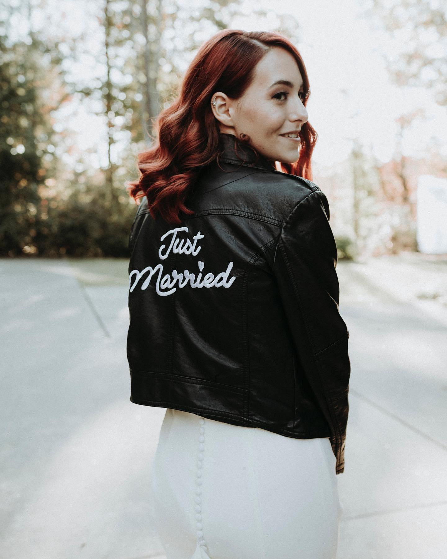 bride with "just married" leather jacket
