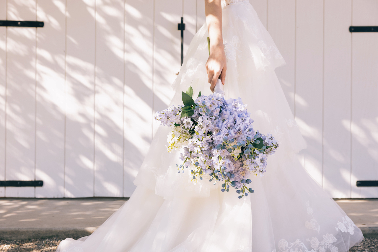 bride holding silk wedding flowers