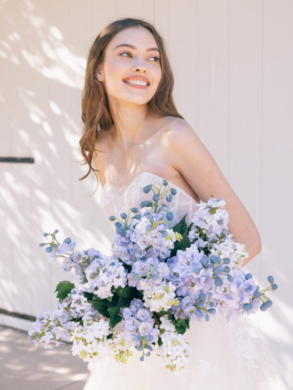 bride with silk wedding flowers
