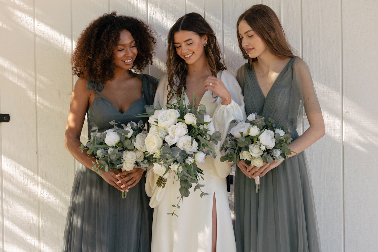 bride and bridesmaids with silk wedding flower bouquets 