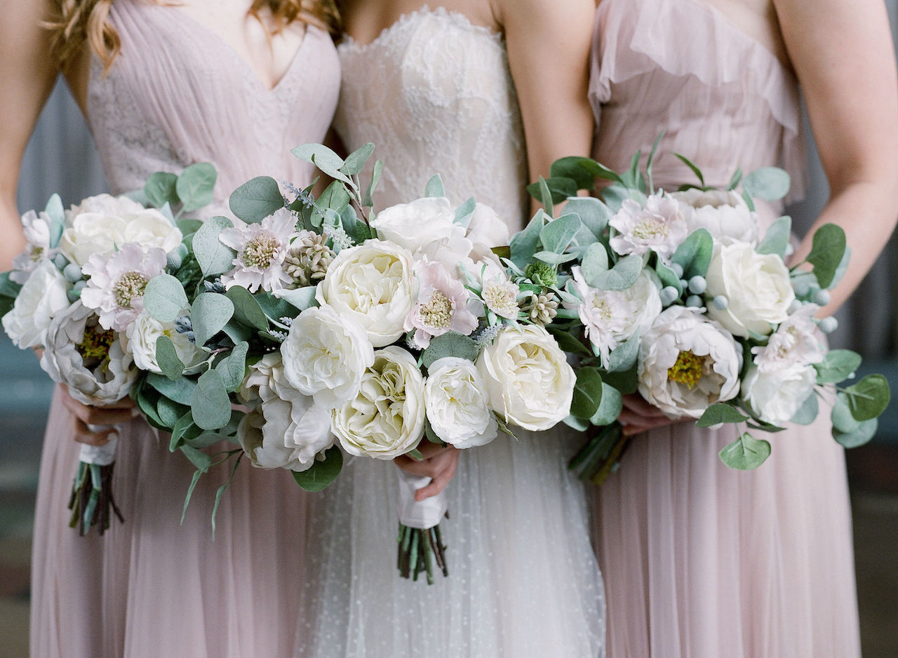 bride and bridesmaids holding silk wedding flowers