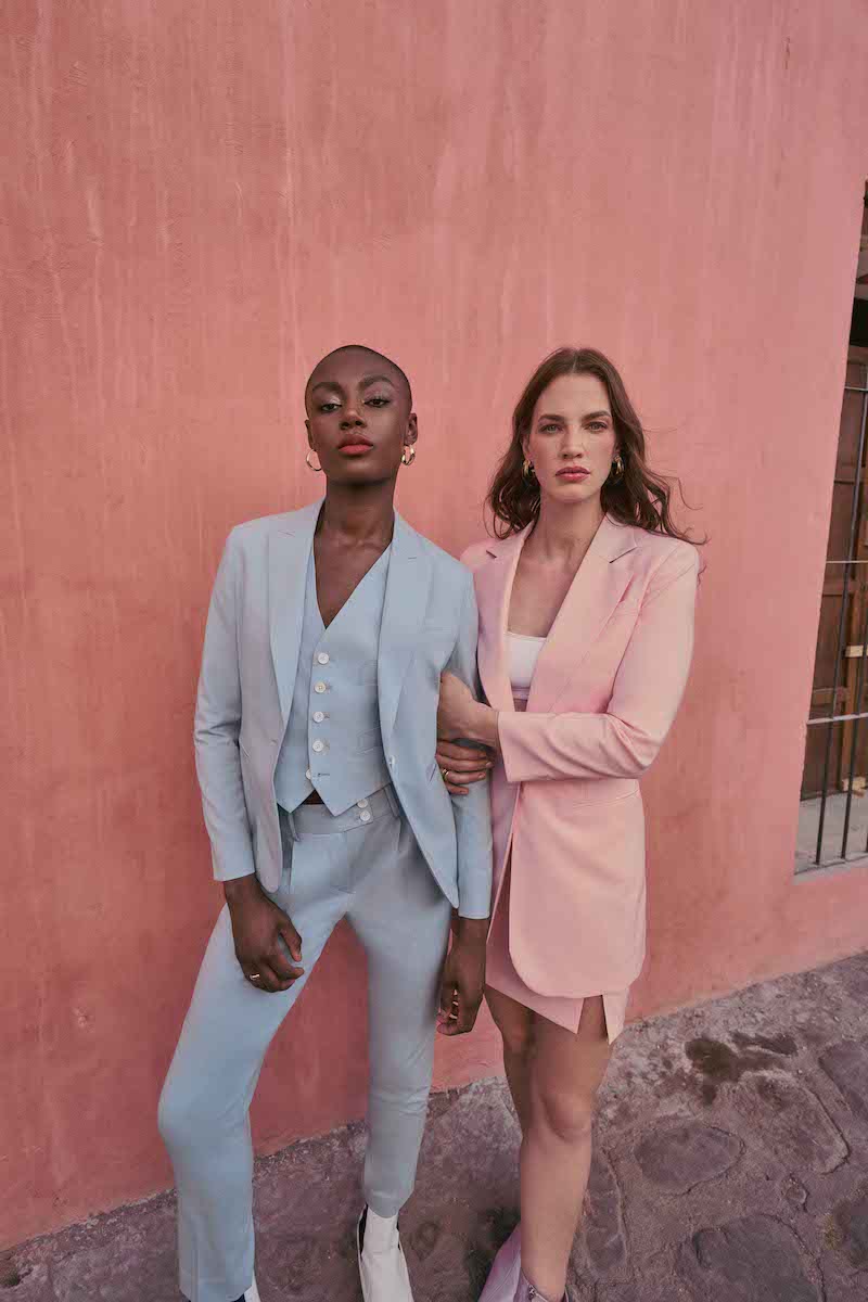 woman in powder blue suit and woman in pink skirt and blazer set